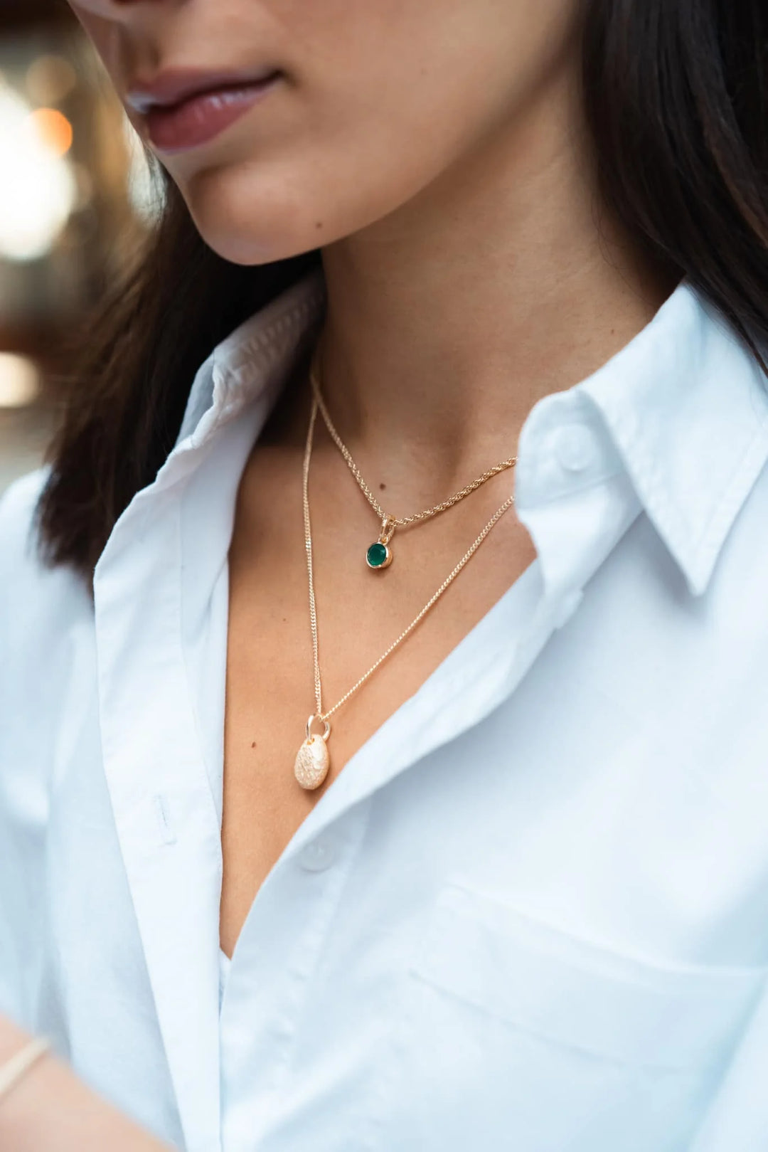 2 necklaces on a woman's neck