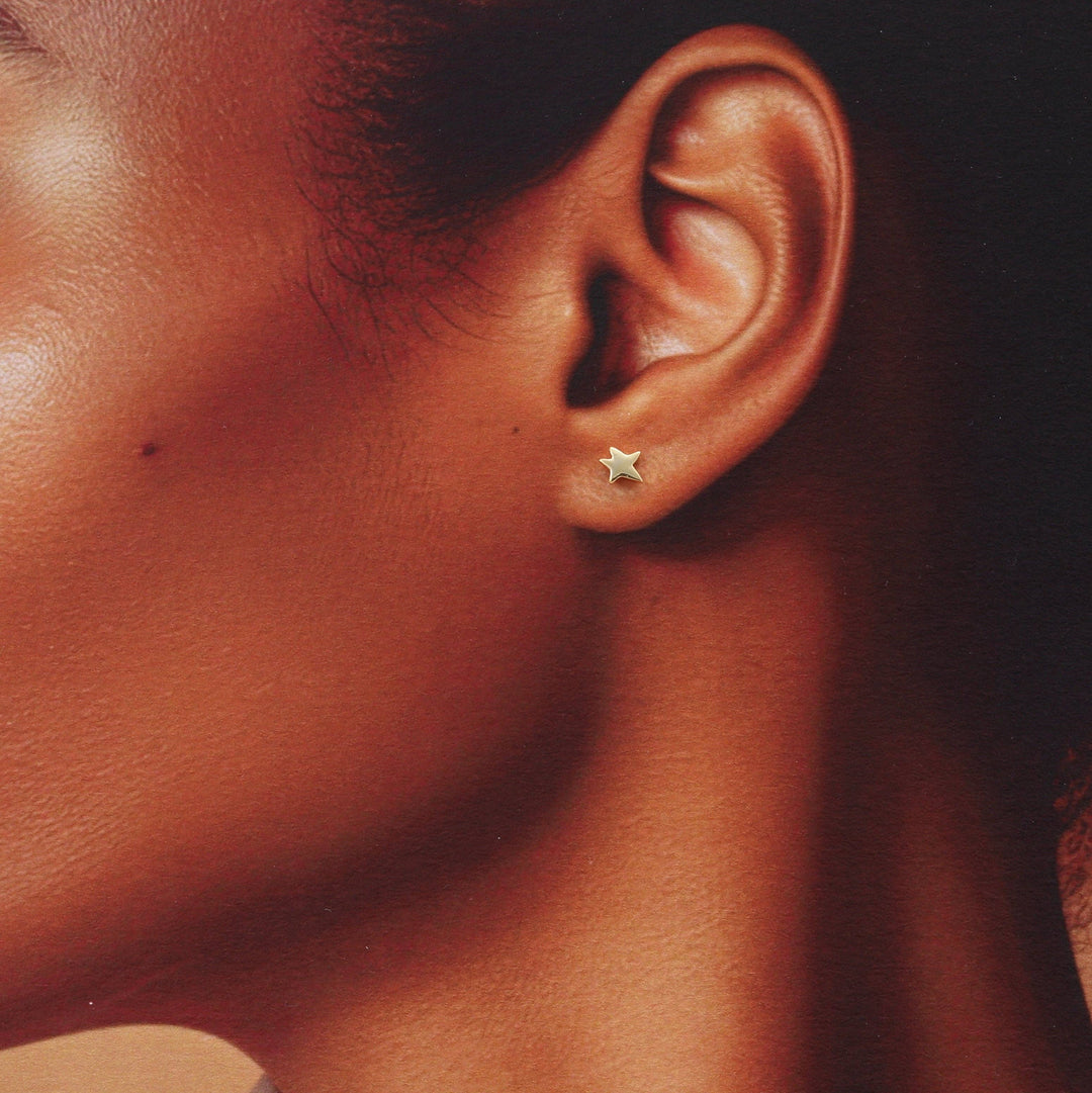 XT013 Gold Star Earrings with penguin graphic